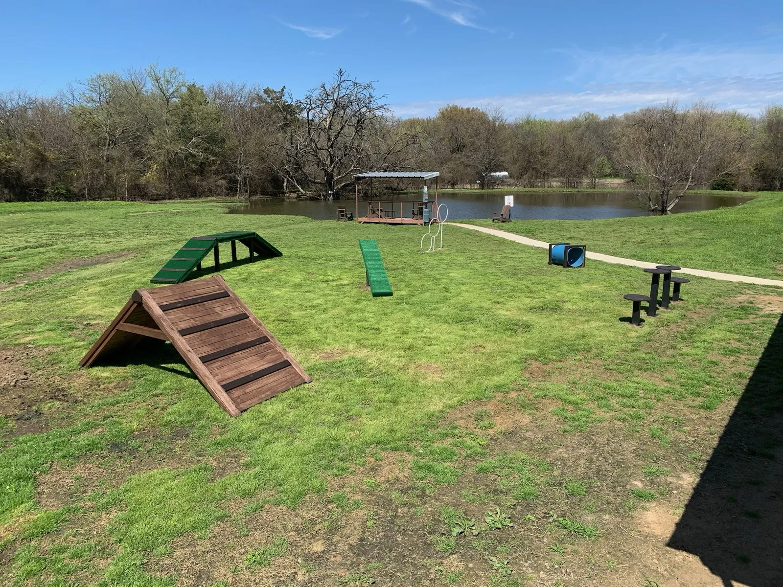 The dog agility course, pond, and dock at Waggin' Tail Ranch RV Resort in Pilot Point, TX