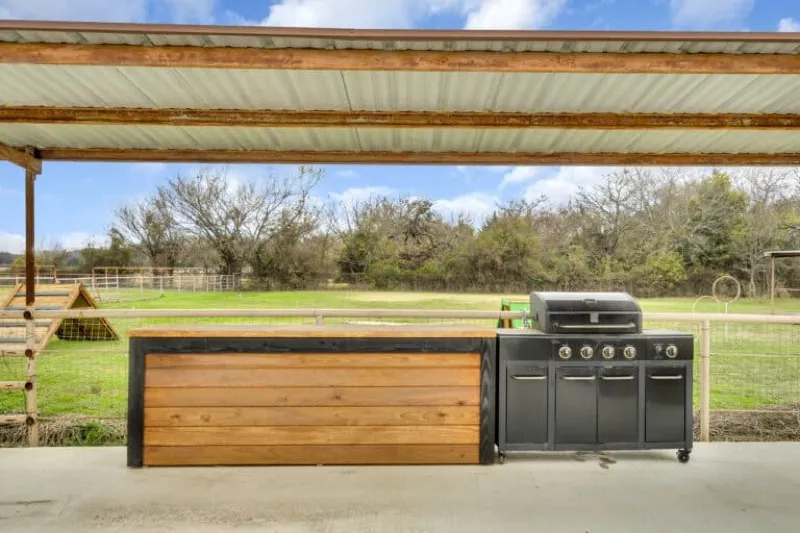 The outdoor cooking area with grills at Waggin' Tail Ranch RV Resort in Pilot Point, TX