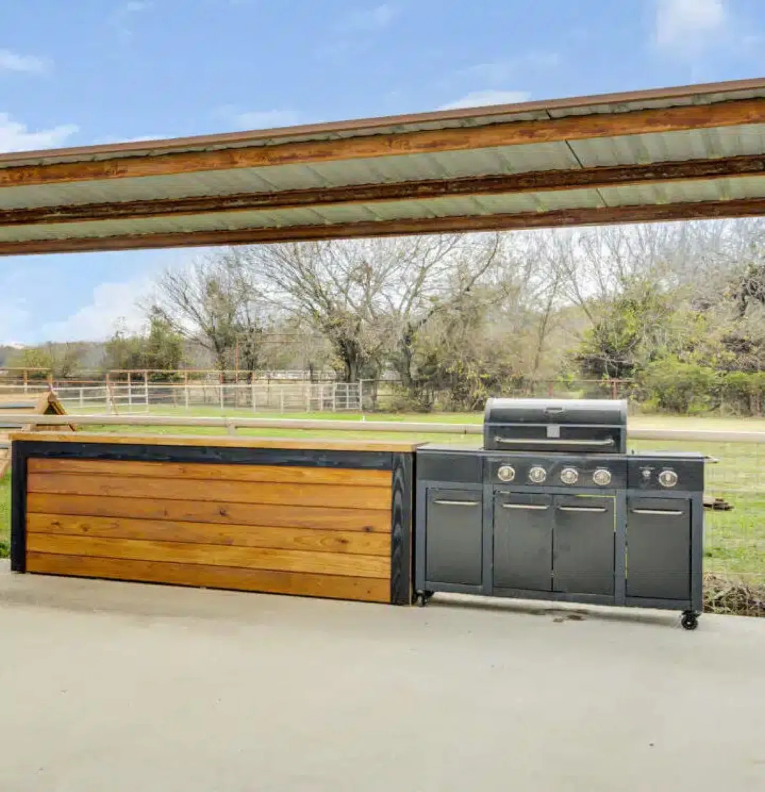 The outdoor cooking area with grills beside the pavilion at Waggin' Tail Ranch RV Resort, Pilot Point, TX