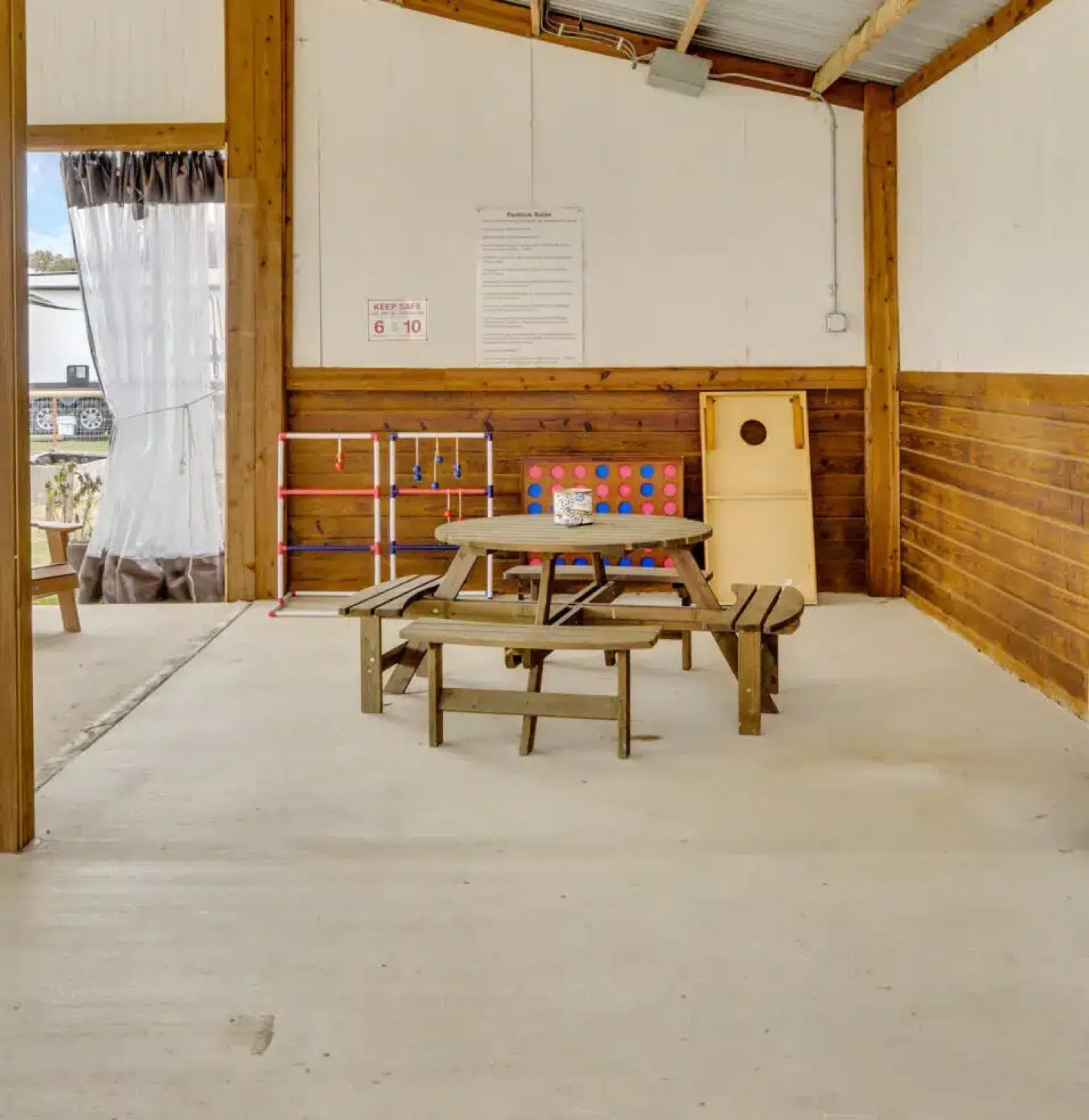 Games set up under the pavilion on a guest game night at Waggin' Tail Ranch RV Resort