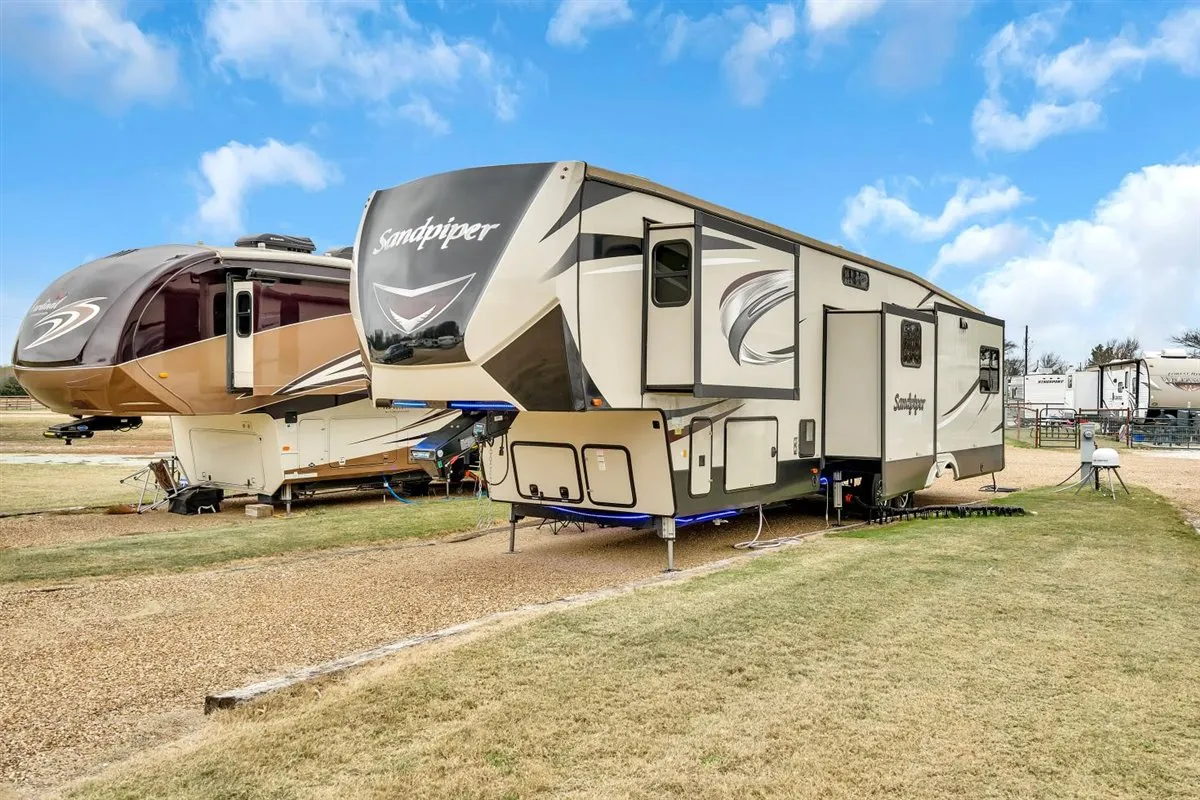A pull-through RV site at Waggin' Tail Ranch RV Resort in Pilot Point, TX